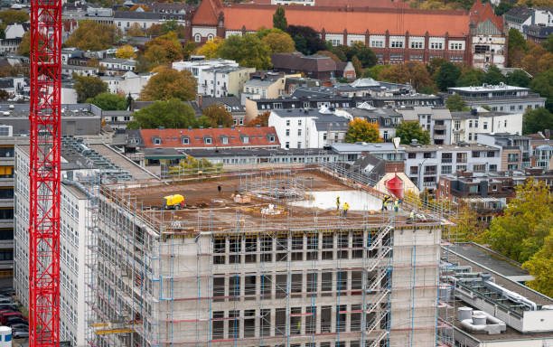 istock Workers fill the roof a a new builing with cement at a construction site. 1434158210