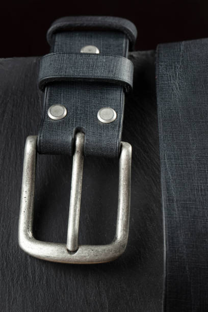 istock Black leather belt on a dark background. Leather products. 1434158816