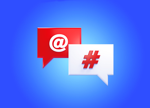 Hashtag and at symbol written speech bubble pair over blue background. Horizontal composition with copy space. Front view.