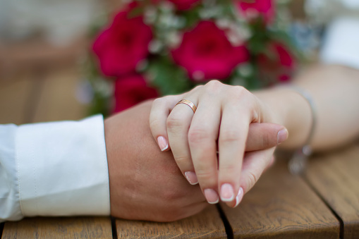 Marriage and love. Male and female hand with a wedding ring.