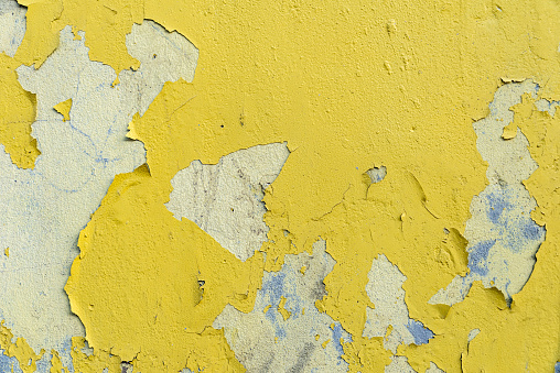 wall texture with yellow paint chipped and cracked in places