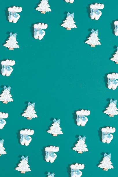 istock Creative composition made of gingerbread christmas
trees and reindeers against green background. Christmas and New Year visual. Minimal flat lay holiday pattern with copy space. 1434162856
