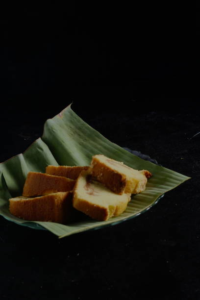 istock cake in a banana leaf container on a black background 1434163761