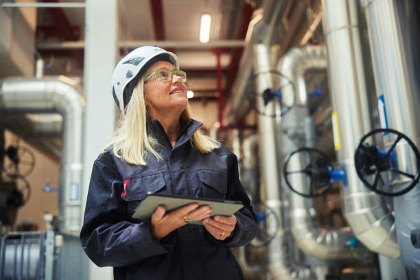 istock Smiling mature engineer standing in a power station with a tablet 1434164796