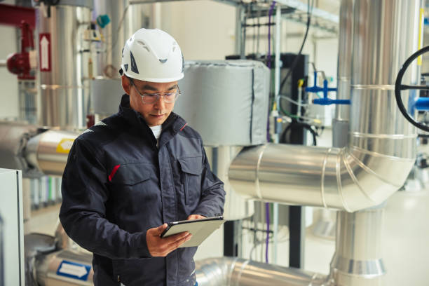 istock Young engineer with a tablet working in a power station 1434165003