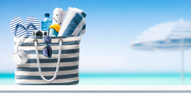 istock Beach bag with accessories and tropical beach 1434167068