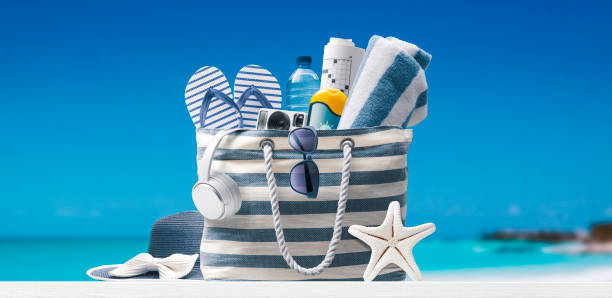 istock Beach bag with accessories and tropical beach 1434167571