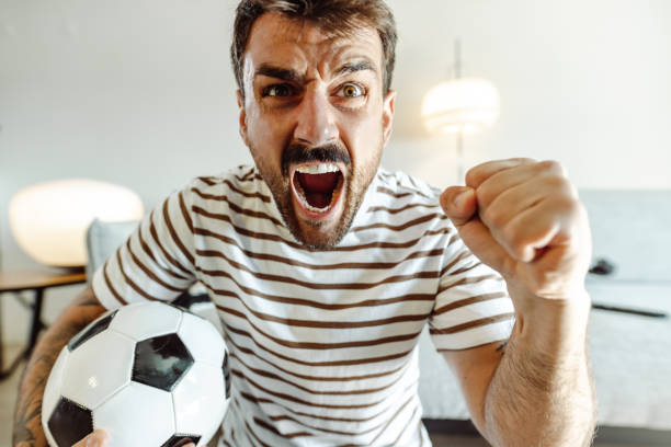 istock Cheering and watching a sports game at home 1434168322