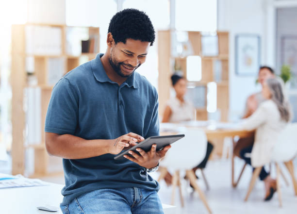 istock Black man business planning online digital tablet, internet and web apps technology in startup agency. Happy entrepreneur, smile creative worker and african designer connect 5g wifi in trendy office 1434169235