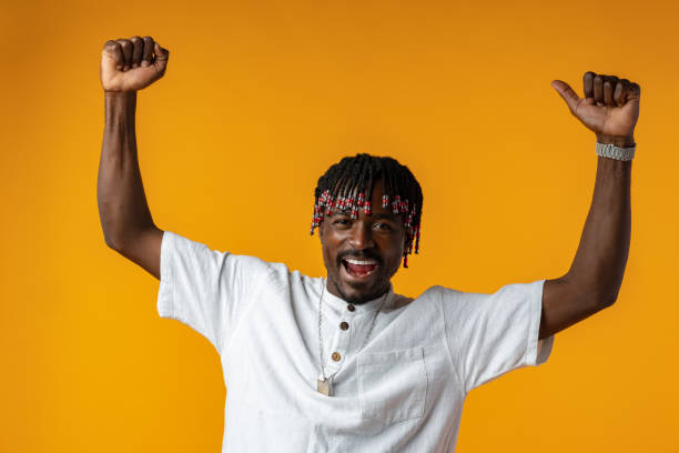 istock Young african man standing over yellow background doing winner gesture 1434170208