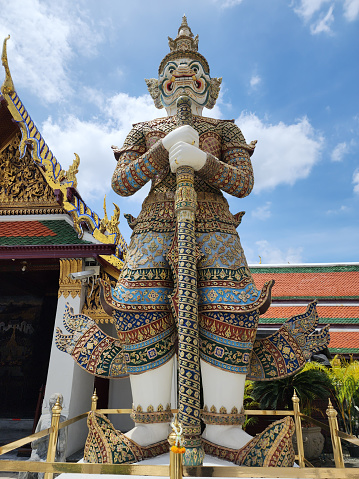 The giant guarding the temple's door at Wat Phra Kaew.The second one has a name,SAHASSADEJA, white body with 1,000 heads 2,000 standing and holding a mace.It is a very powerful giant. Bangkok,Thailand