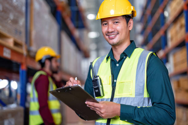 istock Worker in warehouse holding check list tablet pc stand portrait photo 1434170858