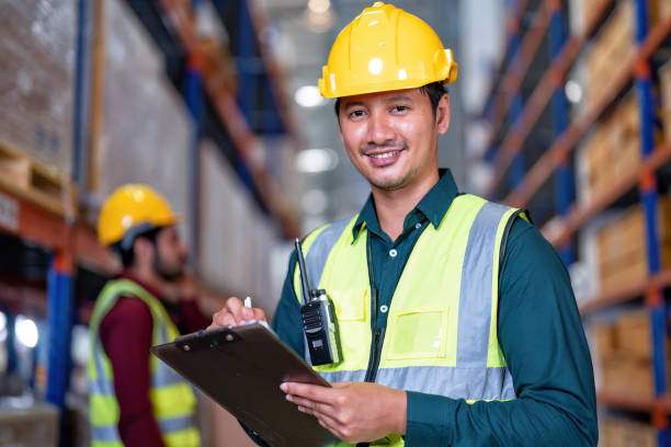 istock Worker in warehouse holding check list tablet pc stand portrait photo 1434170860