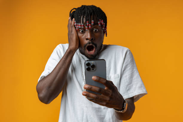 istock Young african man using smartphone over isolated yellow background 1434171678