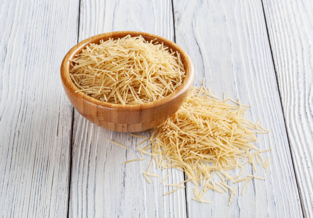 istock Uncooked vermicelli pasta on white wooden table 1434173844