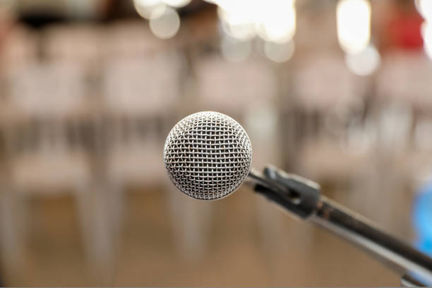 istock Microphone on Stage Against a Background of chairs. 1434175727