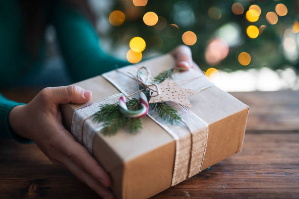 istock Woman giving a Christmas gift. 1434177576