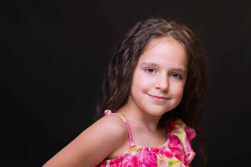 Eight-year-old brunette happy to be photographed in her favorite dress.