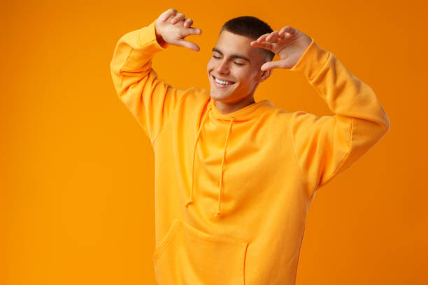 istock Handsome young man dancing near yellow wall 1434177794