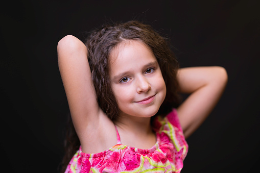 Pretty 8-year-old girl posing for the camera.
