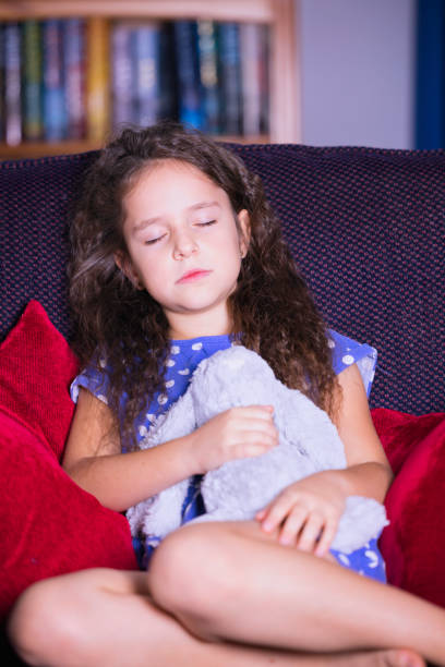 istock Little girl sleeping with her cuddly toy 1434178880