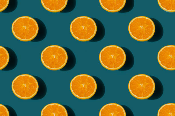istock seamless pattern of ripe tasty orange cut in half on a blue background 1434185507