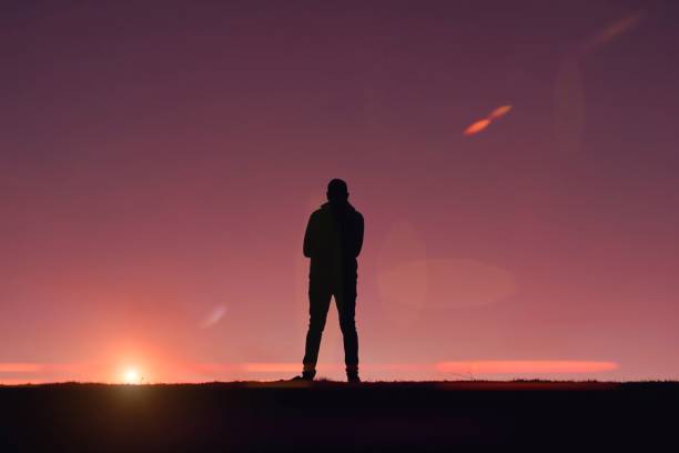 istock man trekking in the mountain with a sunset background in summertime 1434186530