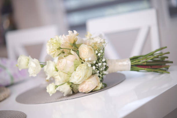 Horizontal background shot with large ivory roses heads, with bokeh effect, copy space and selective focus.
