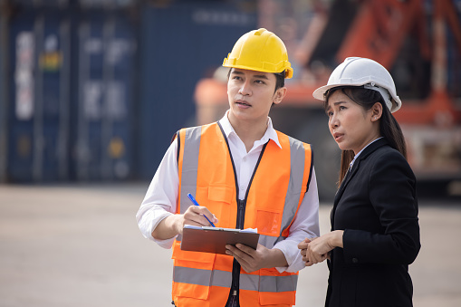 Female Asian Manager with His Engineer Team Having a Team Discussion Meeting at an Industrial Site