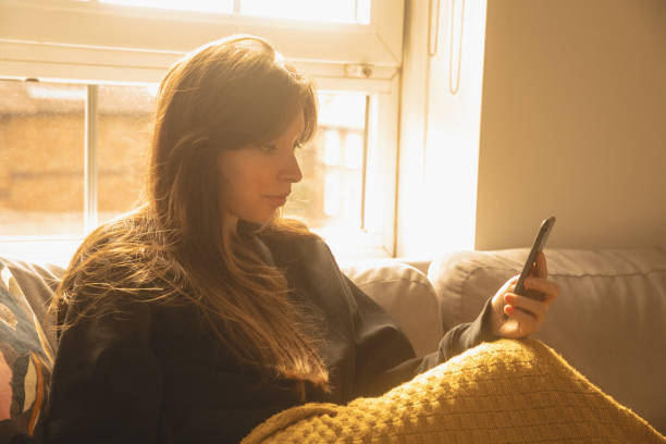 istock Woman at home using smartphone carefree 1434192517
