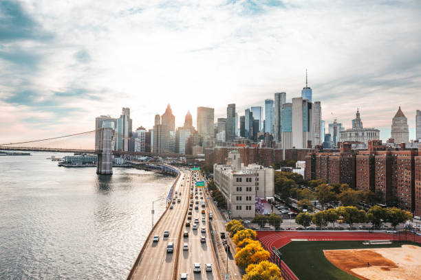 View at sunset to Lower Manhattan buildings, Brooklyn Bridge and FDR Drive.