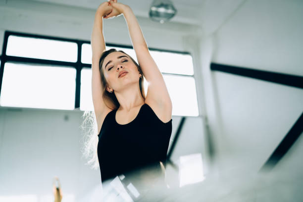 istock Sportive young female having stretch in studio 1434197563