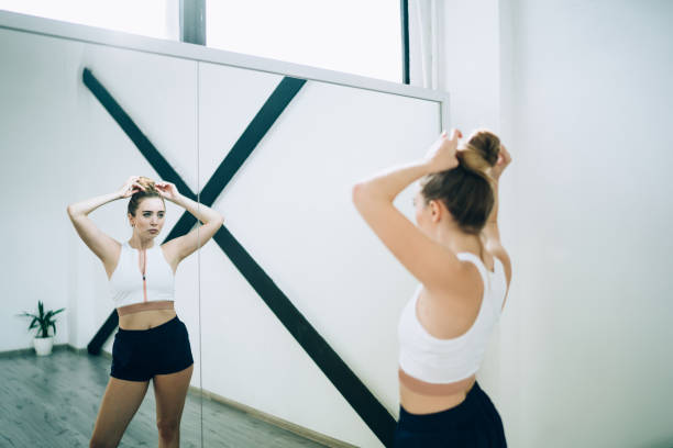 istock Sportive woman looking at mirror in studio 1434197569