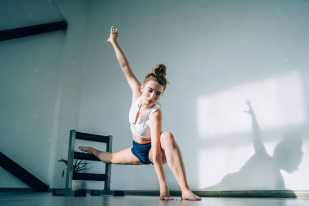 istock Serious woman stretching body in class 1434197583