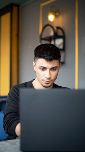 istock Young handsome man working with laptop in cafe 1434198905