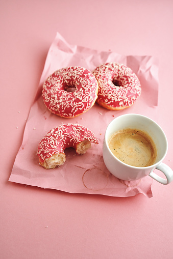 Donuts with Pink Icing Served with Coffee