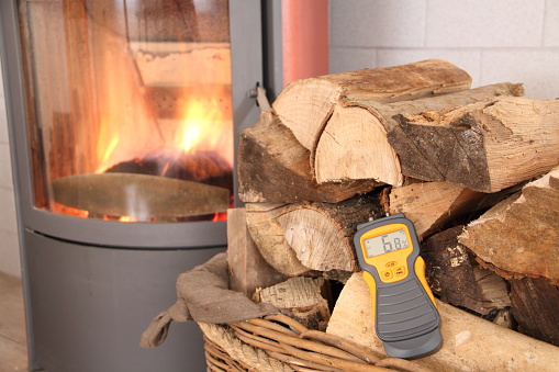 a stove with wood and moisture meter