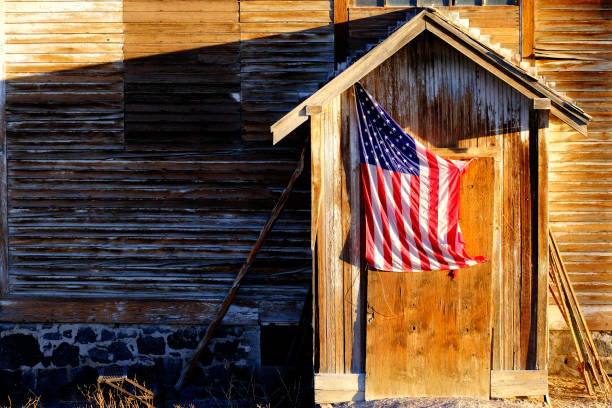 istock Old American Flag on Weathered Building Door 1434200263