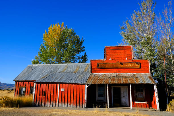 istock Old Abandoned Red Store Storefront with Blue Sky and Trees 1434200286