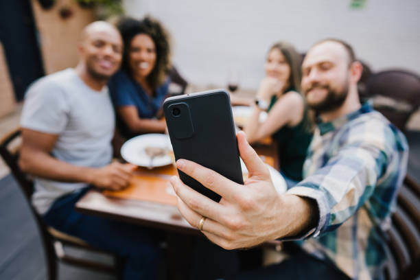 istock Group of friends taking selfie at restaurant 1434202907