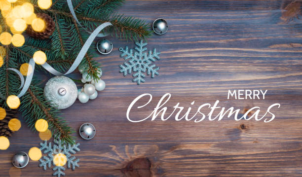 istock Flat lay christmas composition with fir branches and christmas decorations, garland on a wooden table. Winter holiday background with text merry christmas 1434204188