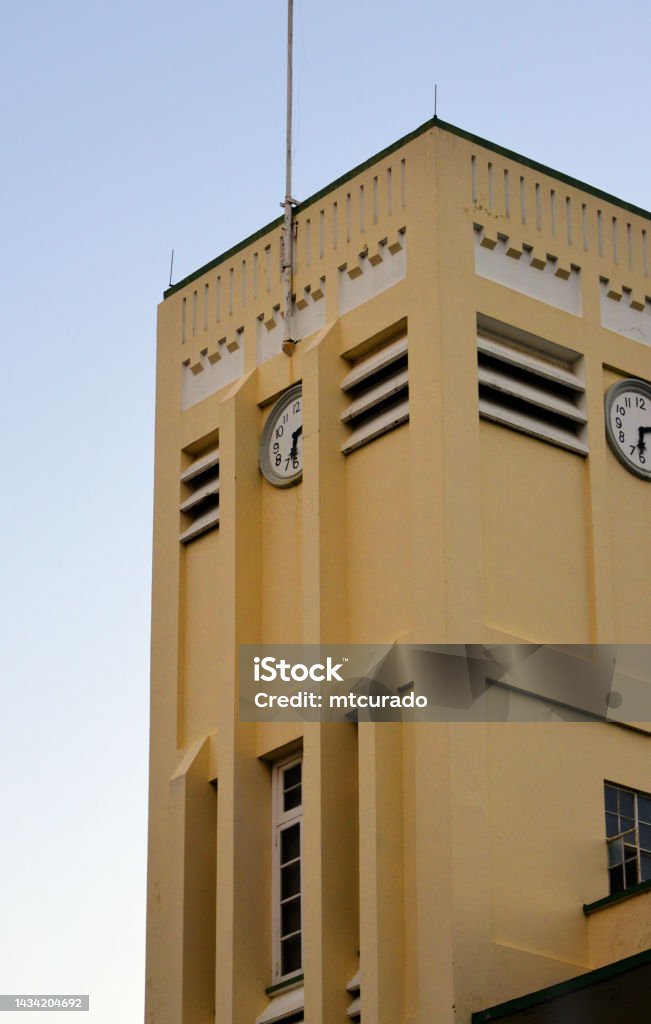 Saint Mary's College (CIC) - art deco tower at dusk, Port of Spain, Trinidad and Tobago Port of Spain, Trinidad island, Trinidad and Tobago: Holy Ghost Fathers Saint Mary's College / College of the Immaculate Conception (CIC) - Catholic secondary school, one of the leading boys schools in TnT, Frederick Street - Tower with clocks - Trinidadian Art deco style building completed in 1943, the school was founded in 1863. Antilles Stock Photo