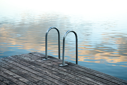 Swimming rails on the lake, woodwork by the river, texture difference.