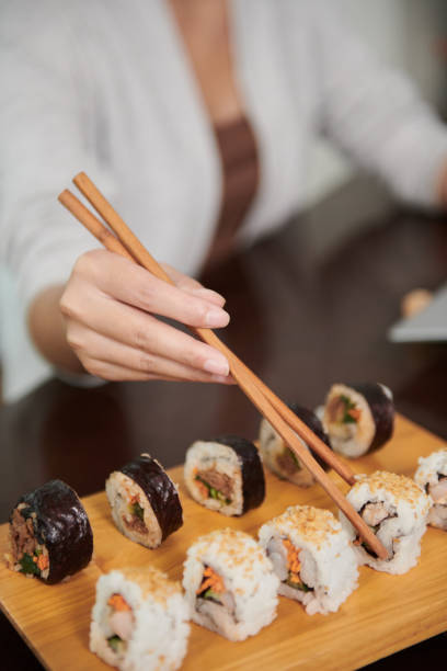 istock Woman Eating Delicious Sushi 1434207911