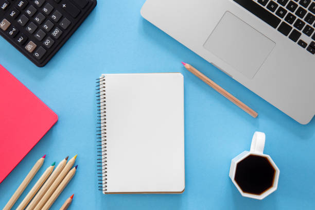 istock Flat lay, notepad, laptop and stationery on blue background. 1434209111