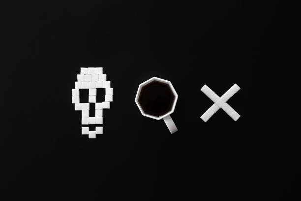 istock Skull bones from sugar and cup of coffee on black background, flat lay. 1434210305