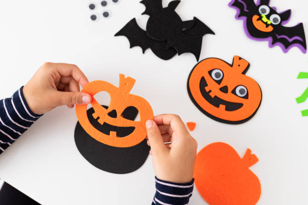 istock child making craft pumpkin for halloween holiday 1434210321