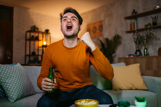 istock Young Man Watching A Sports Game At Home 1434210558