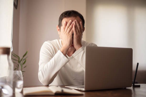 istock Mid adult man is working from home. A man having problems with his job. 1434210846