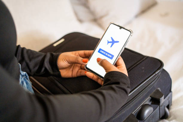istock Young woman using an app to check-in for a flight 1434211169